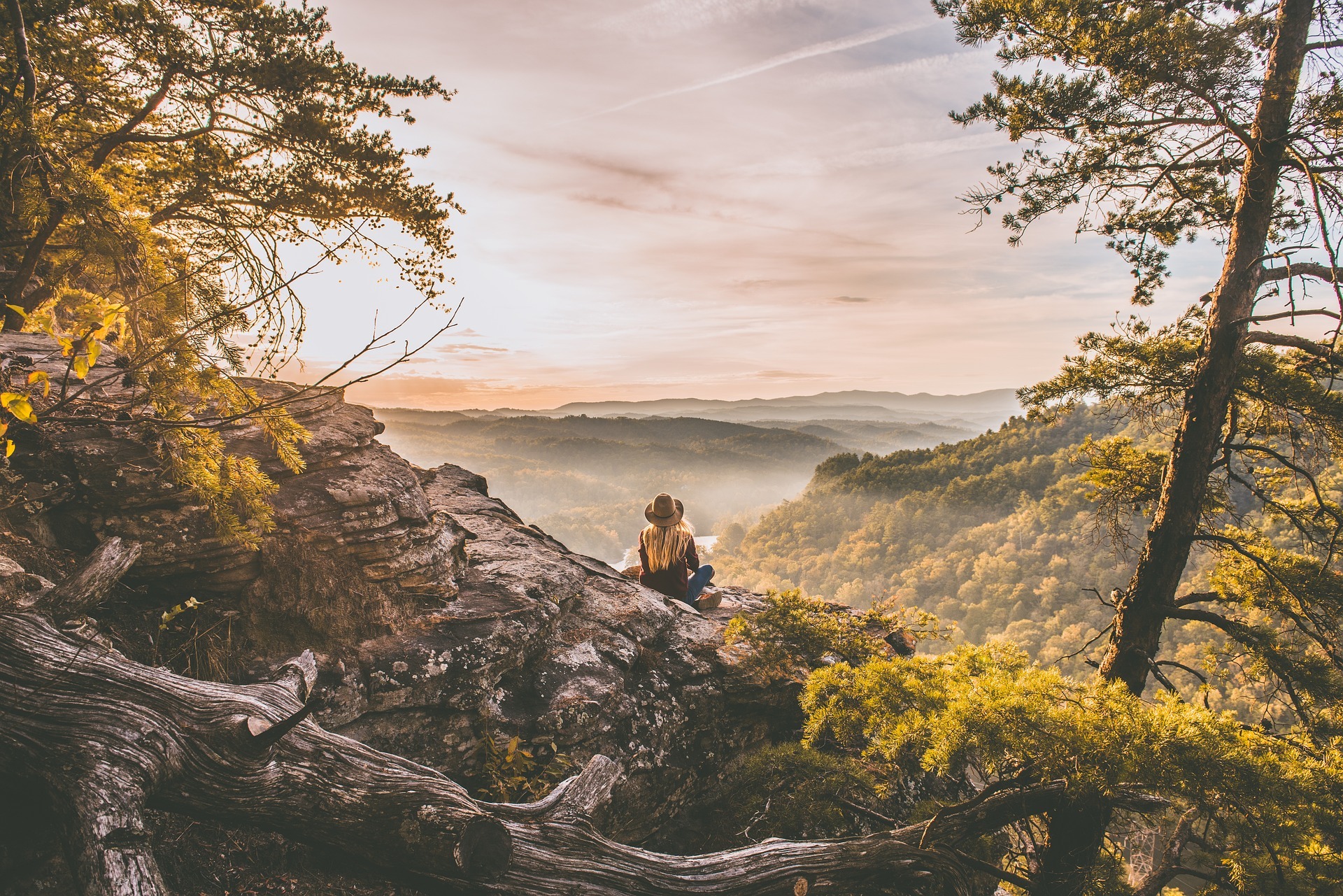 Woman-sitting-peak-overlooking