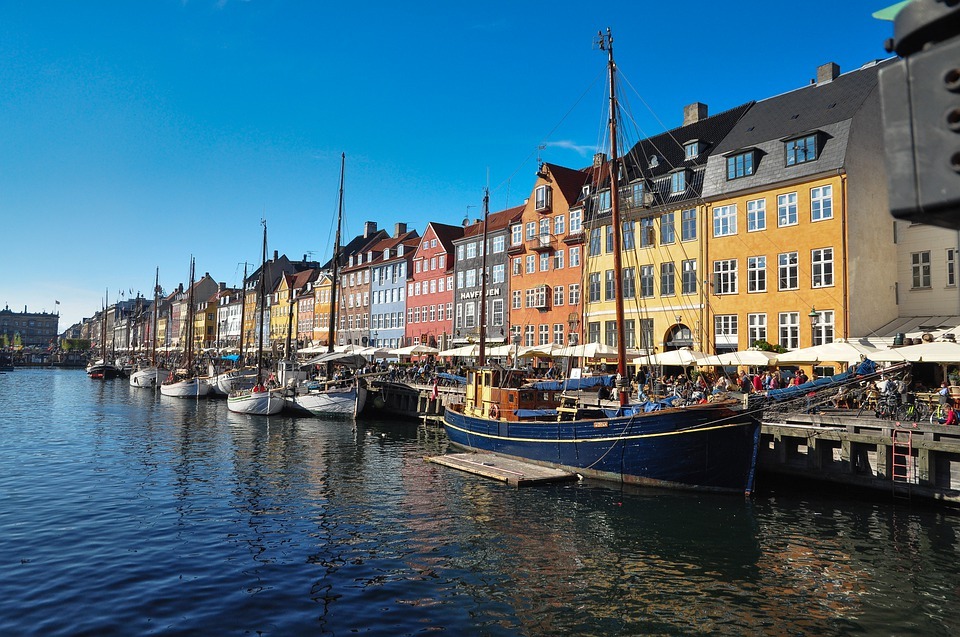 A view of Copenhagen with boats and colorful houses