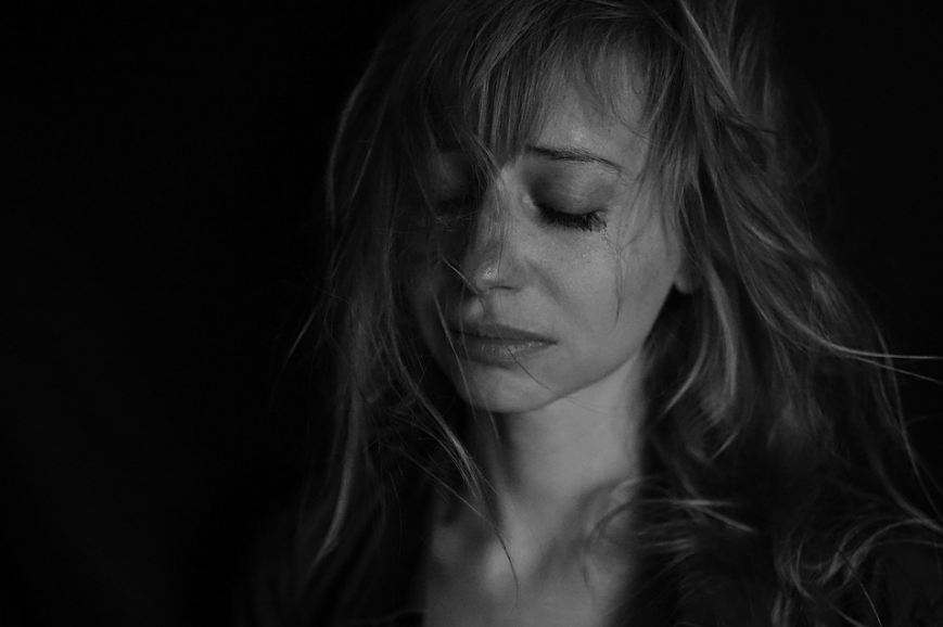 A portrait shot of a woman crying