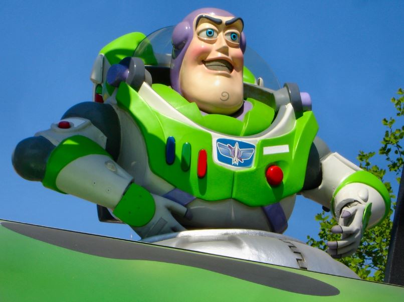 A large inflatable statue of Buzz Lightyear at a parade