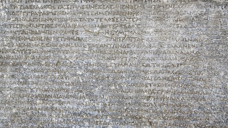 Ancient Greek writing on rock for background